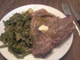 A picture of T-Bone Steak w/Lemon Herb Butter and Vegetable Medley.