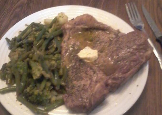 A picture of T-Bone Steak w/Lemon Herb Butter and Vegetable Medley.