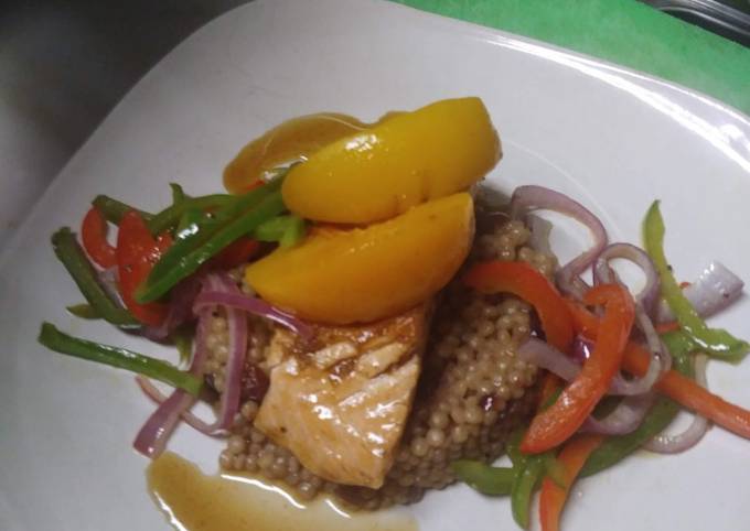 A picture of Peach Bourbon Salmon w/ Cranberry Cous cous and Vegetable Medley.