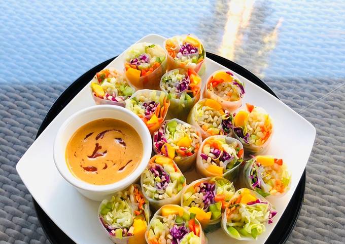 A picture of Rainbow Vegetables Rolls with Peanut Sriracha Dipping Sauce.