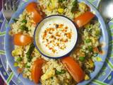 A picture of Colourful healthy rice with lots of paneer, Corn & vegetables.