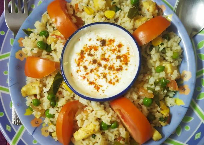 A picture of Colourful healthy rice with lots of paneer, Corn & vegetables.