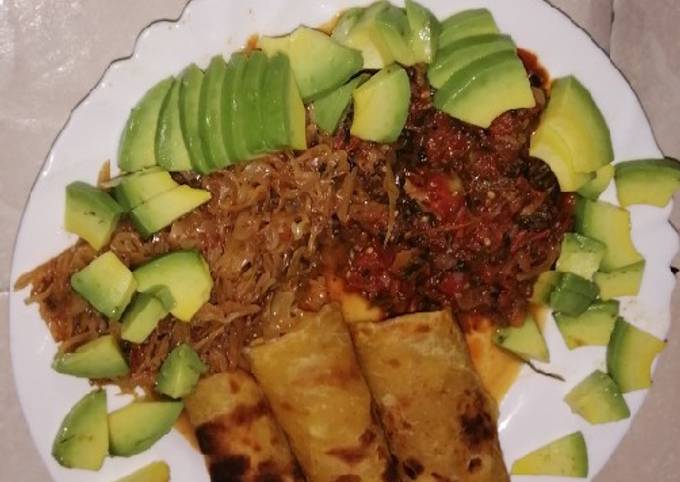 A picture of Traditional matumbo stew, served with chapati and cabbage.