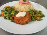 A picture of Fish fillet in breadcrumbs,braised rice and mixed vegetables.