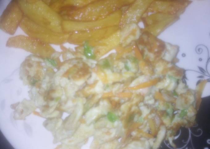 A picture of Homemade French fries and vegetables scrambled egg.