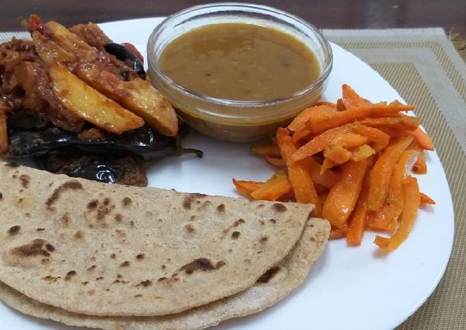 A picture of Brinjal n Potatoes with daal n roti n carrots# Indian dish conte.