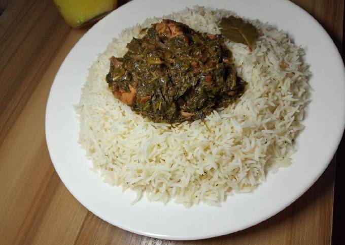 A picture of White rice with chicken vegetable soup.