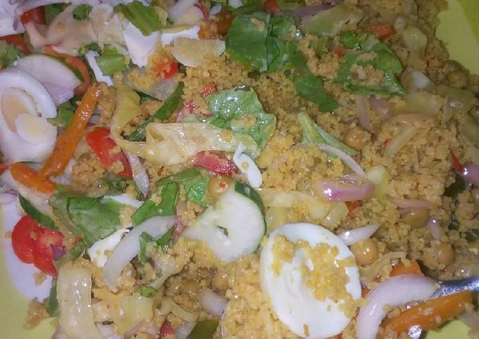 A picture of Veg couscous with salad.