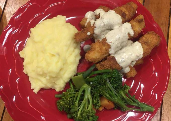 A picture of ParmFish fingers served with creamy mash and assorted vegetables.