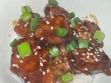 A picture of Orange Chicken with White Rice.