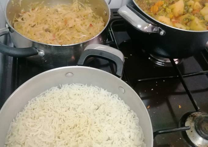 A picture of Mixed vegetable stew with minced meat, rice and a side of cabbage.