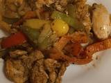 A picture of Tandoori marinated chicken thighs with mixed peppers and onion.