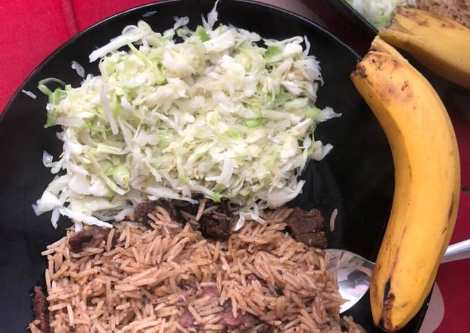 A picture of Beef pilau and steamed cabbages.