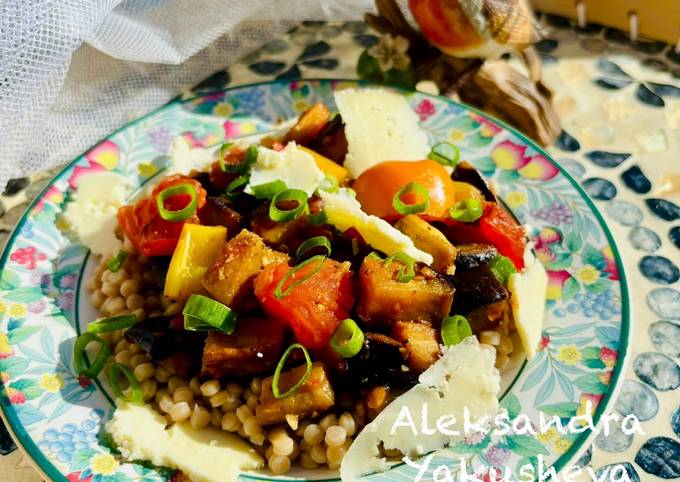 A picture of Warm aubergine salad with giant
wholewheat couscous and smoked cheese.