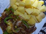 A picture of Boiled potatoes with fish in vegetable sauce.