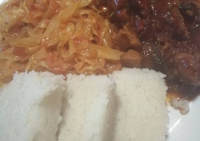 A picture of Ugali, cabbage and wet fry beef.