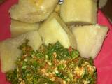 A picture of Boiled yam with vegetable sauce.