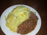 A picture of Tumeric rice, beans and steamed cabbage.