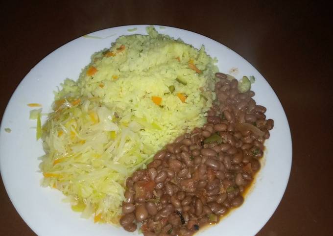 A picture of Tumeric rice, beans and steamed cabbage.