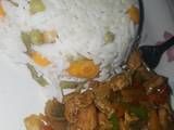 A picture of Vegetables rice and chicken stir fry.