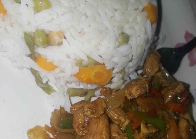 A picture of Vegetables rice and chicken stir fry.