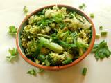 A picture of Fried rice topped with green veggies.