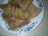 A picture of Brown ugali with mutton and cabbage.