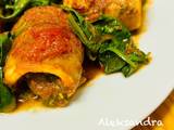 A picture of Cod rolls with tomatoes and spinach.