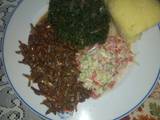 A picture of Fried Omena,kienyeji mboga mix,coleslaw salad,semolina ugali.