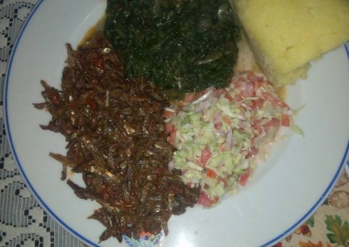 A picture of Fried Omena,kienyeji mboga mix,coleslaw salad,semolina ugali.