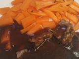 A picture of Roast beef with carrots, sweet potato chips & mint gravy.