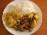 A picture of White rice with beaf stew & steamed cabbage.