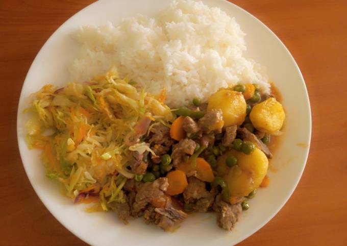 A picture of White rice with beaf stew & steamed cabbage.