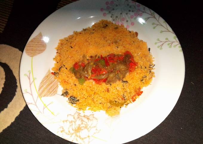 A picture of Dambun shinkafa with Shredded mutton and vegetables sauce.