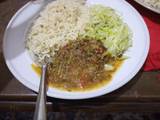 A picture of Rice with ndengu and steamed cabbage.