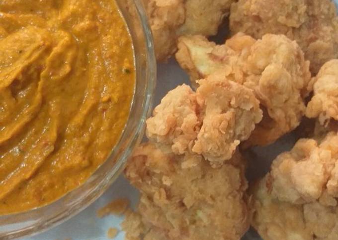 A picture of Chicken fried cauliflower with vegetable sauce.