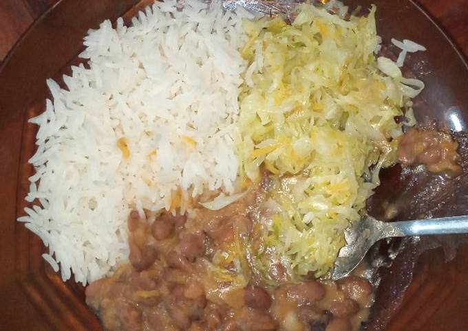 A picture of Stewed beans served with rice and cabbage.