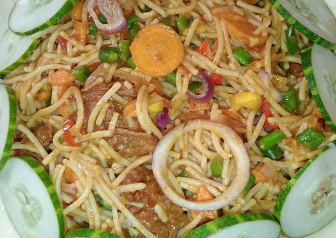 A picture of Pasta with stir fried vegetables and beef.