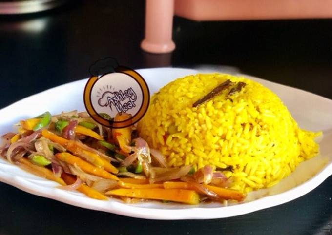 A picture of Yellow rice with stir vegetables.