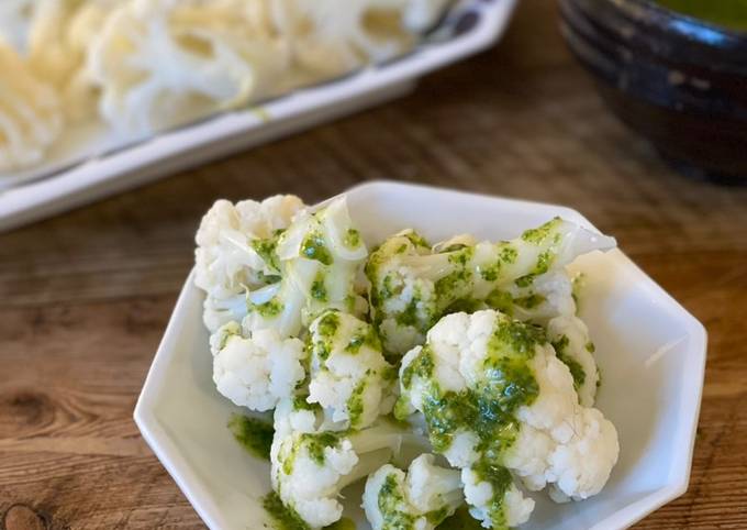 A picture of 🥦 Steamed cauliflower with green sauce.