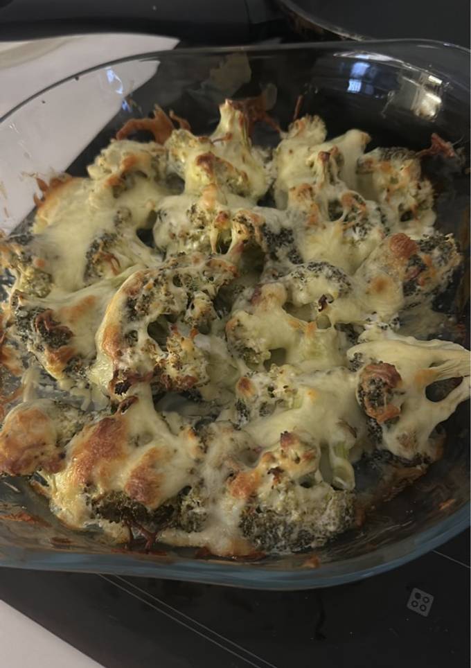 A picture of Baked Broccoli marinated with yogurt and topped with mozzarella.