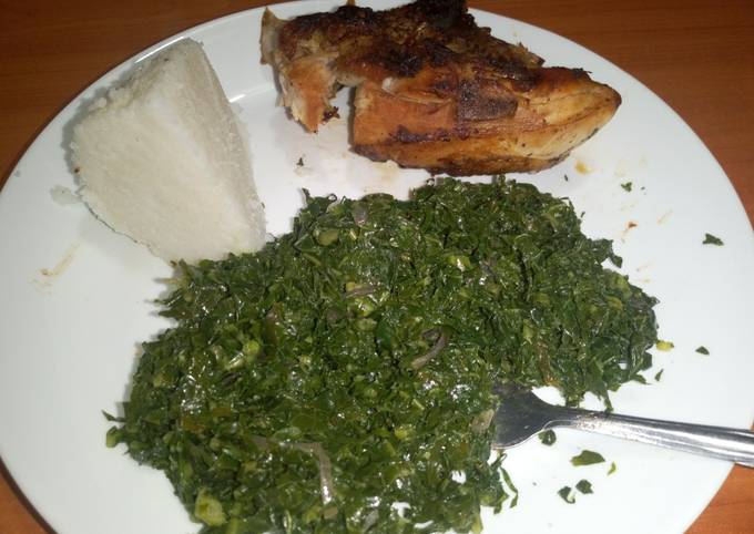 A picture of Grilled chicken served with fried kales & ugali.