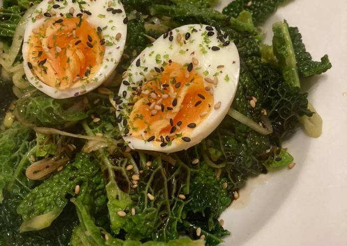 A picture of Savoy cabbage with soft boiled eggs and furikake.