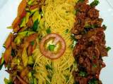 A picture of Spaghetti on tomato sauce,wet fry beef, sauteed vegetables..,.