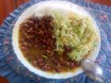 A picture of Boiled rice and fried red beans with steamed cabbages.