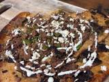 A picture of Lebanese Style Spiced Beef Pizza with homemade lemon garlic yoghurt sauce topped with Za’atar.