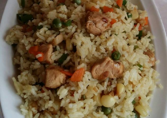 A picture of Chicken stir fry with rice and vegetables.