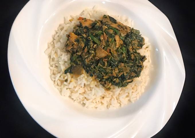 A picture of White rice and vegetable sauce.