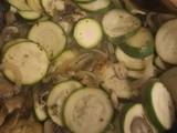 A picture of Salmon fillets with courgettes onion and mushrooms.