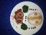 A picture of Braised rice with mutton stew and fried kales.